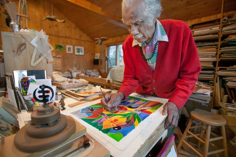Ashley Bryan painting in his home studio in Islesford, Little Cranberry Island, Maine, in January 2010.