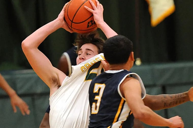 Lansdale Catholic's Dan Modestine, left, has his shirt pulled by
West Catholic's Jeohni Moore, right, in the first quarter of play
Friday, Jan. 2, 2014 in Lansdale, Pa. (Bradley C
Bower/Staff Photographer)