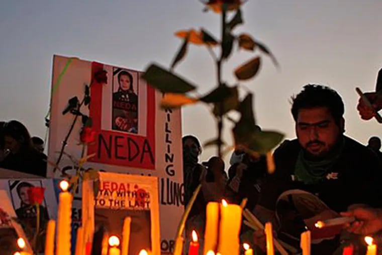 Iranians in Dubai light candles in front of an image of Neda Agha Soltani, who was reportedly killed when hit by a bullet during a protest in Tehran. (AP Photo / Kamran Jebreili)