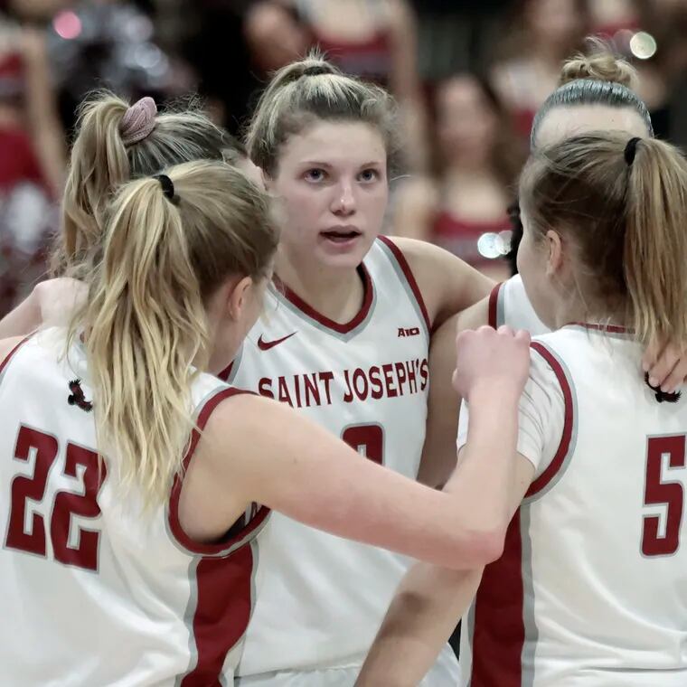 Talya Brugler (center) and the St. Joseph's Hawks improved to 23-2 with a rout of Dayton on Wednesday night. They are shown in a game on Feb. 3.
