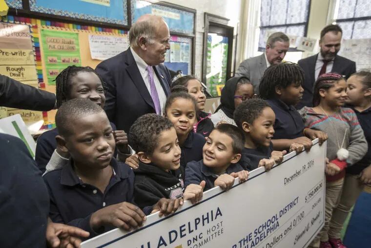 Students in Jamie Ott’s third-grade class gather around former Gov. Ed Rendell to hold up a huge check for $750,000 to the school district for books on Monday at Ludlow Elementary School.