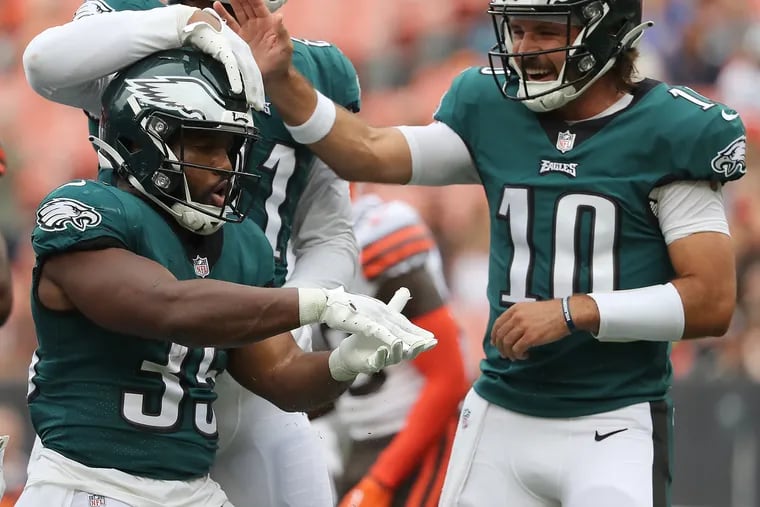 Philadelphia Eagles running back Boston Scott (left) celebrates his touchdown with teammates Richard Rodgers (center) and quarterback Gardner Minshew (right) during the first quarter as the Philadelphia Eagles play the Cleveland Browns in a preseason game in Cleveland, Ohio on Sunday, Aug. 21, 2022.