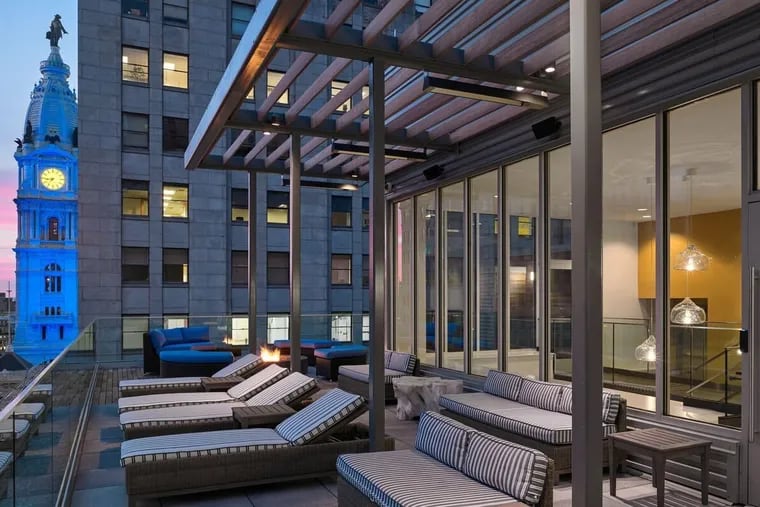 A shared rooftop deck with fire pits, outdoor grills and lounge seating at the Griffin apartments at Broad and Chestnut Streets.