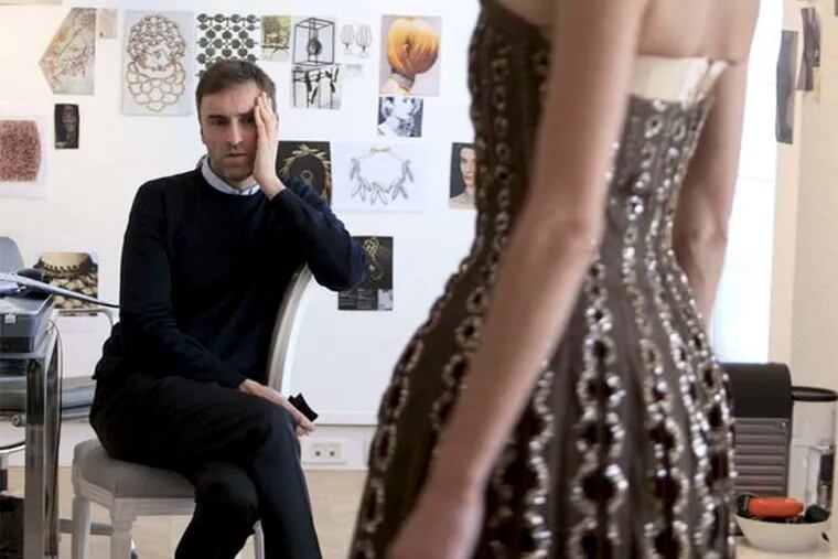 Raf Simons, Dior's new creative director, takes stock of a vintage Dior dress in 'Dior and I.' (CIM Productions.)