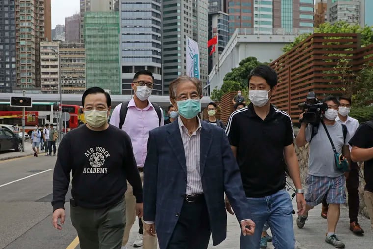 Former pro-democracy lawmaker Martin Lee, 81-year-old, center, leaves a police station in Hong Kong, Saturday, April 18, 2020. Hong Kong police arrested at least 14 pro-democracy lawmakers and activists on Saturday on charges of joining unlawful protests last year calling for reforms.