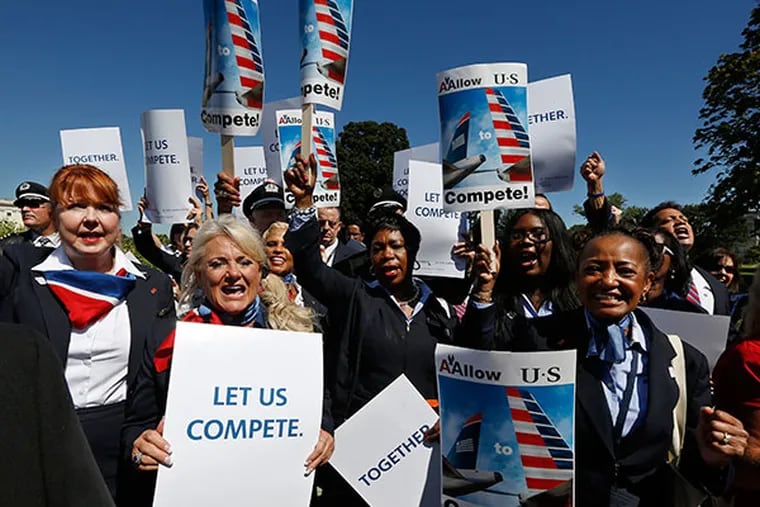 US Airways flight attendants chant during a protest by pilots, flight attendants, baggage handlers and other union members working for American Airlines and US Airways urging the U.S. Justice Department to allow the two companies to merge at a rally in front of the U.S. Capitol building in Washington September 18, 2013. The U.S. Justice Department filed a lawsuit on August 13 to stop the planned merger between US Airways Group and American's parent company AMR Corp.   (REUTERS/Jim Bourg)