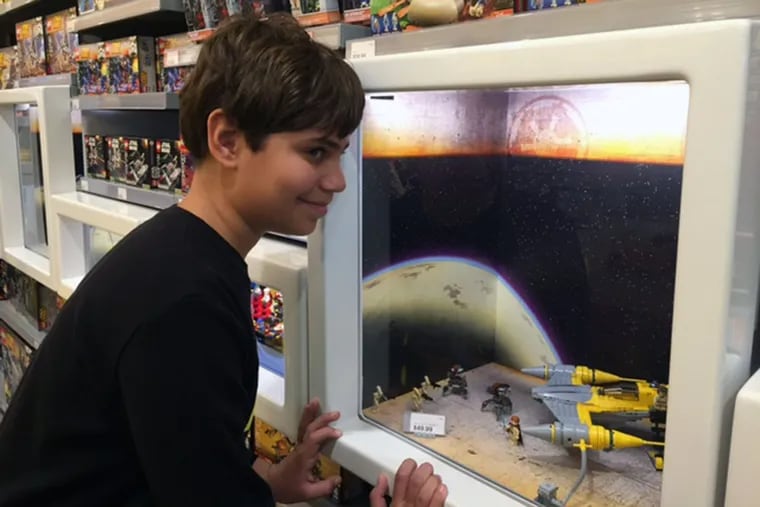 Matthew Becker, 13, of Philadelphia checks out the Star Wars offerings at the Cherry Hill Mall Legos store.