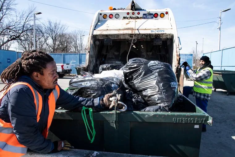 Harry Rollex, left, and P. Stokes, dump trash at the Sanitation Convenience Center in North Philadelphia, Pa. Wednesday, March 13, 2018. The center accepts residents' bulk trash that the city does not pick up at the curb.