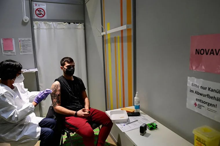 A young man receives a COVID-19 vaccine at the CIZ Tegel vaccination center in Berlin.