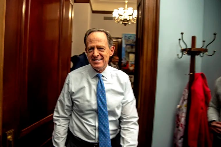 Sen. Pat Toomey (R., Pa.) leaves the office of Sen. Ted Cruz (R., Texas) (not shown) in Washington, D.C. on Nov. 17 after making good on a wager he made before the World Series to deliver Wawa soft pretzels and beer from Yuengling and Yards to the Texas lawmaker if the Phillies lost.