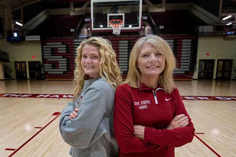 St. Joseph's women's basketball coach Cindy Griffin (right) poses for a photo with her daughter, Kaylie, at Hagan Arena.