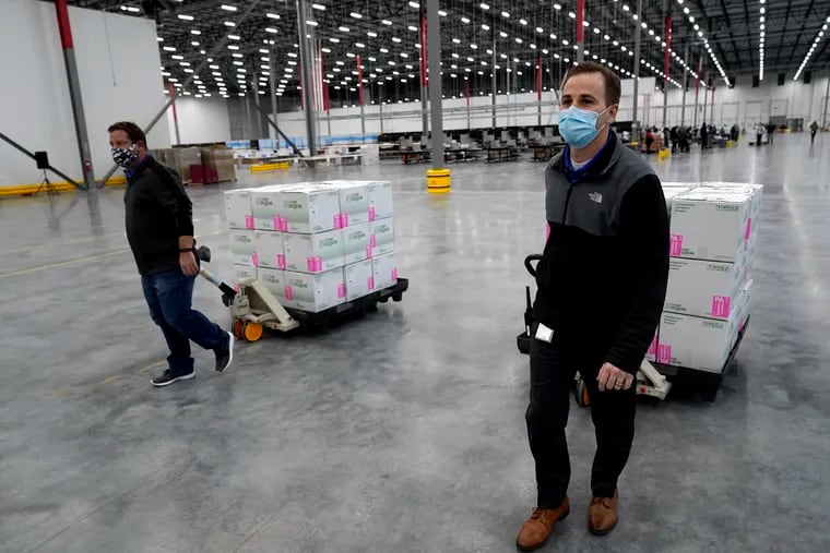 Boxes containing the Moderna COVID-19 vaccine are moved to the loading dock for shipping at the McKesson distribution center in Olive Branch, Miss., Sunday, Dec. 20, 2020.