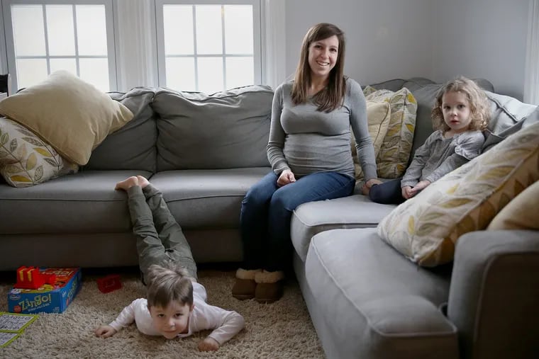 Alyssa Collier, center, sits for a portrait with her children, Mason, 4, left, and Avry, 2, in their Doylestown, Pa., home on Tuesday, Feb. 12, 2019. Collier is expecting another girl in April.