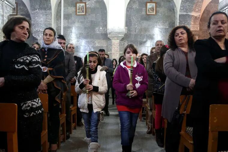 Iraqis at Christmas Eve Mass in the Chaldean Church of the Virgin Mary in al-Qoush, near the battle lines with ISIS.