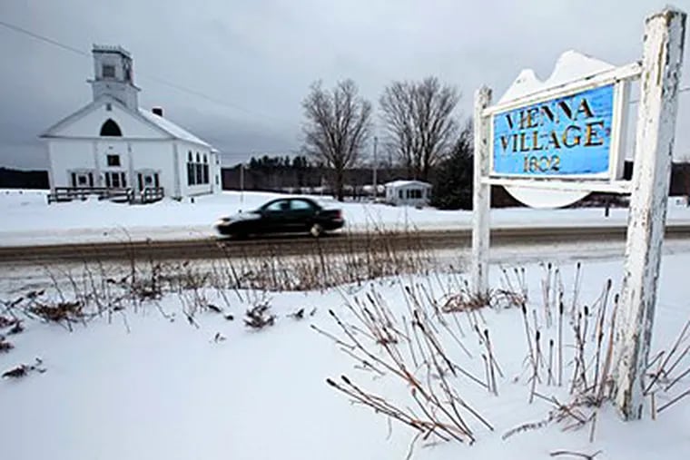 A car passes through the town of Vienna, Maine, after a recent snow. The high cost of pavement has the town considering changing some of its 14 miles of paved roads back to gravel, which is cheaper to maintain. (AP Photo/Robert F. Bukaty)