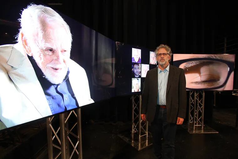 Andy Belser, a professor of movement, voice and acting at Penn State, stands with images from 'FaceAge,' his film project meant to foster communication between older and younger generations.