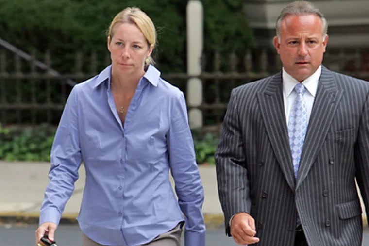 Bonnie Sweeten, the Bucks County mother who faked her own kidnapping in May, and her defense attorney, Louis Busico, walk into the courthouse today. (David Swanson / Staff Photographer)
