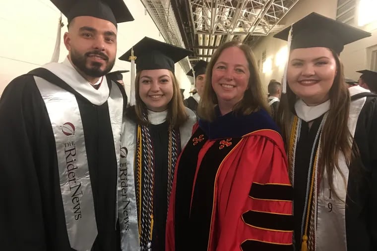 Journalism professor Jackie Soteropoulos Incollingo, in red robes, with student newspaper editors (from left) Rob Rose, Megan Lupo, and Theresa Evans.at Rider University's commencement May 18.