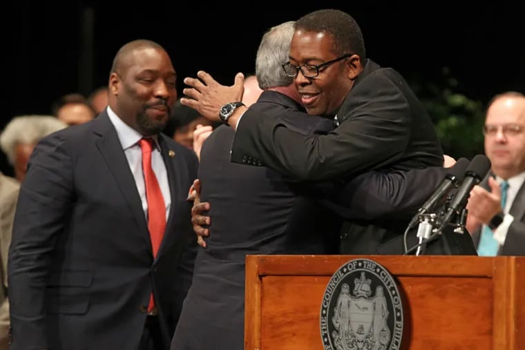 City Council President Darrell Clarke, right, gives Jim Kenney a big hug prior to Kenney being sworn in as the 99th mayor of Philadelphia on Jan. 4, 2015.