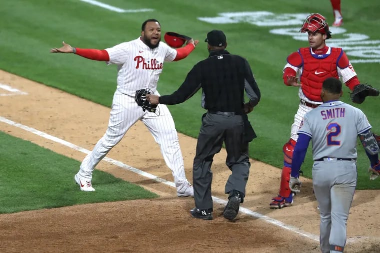 José Alvardo, left, of the Phillies and Dominic Smith of the Mets exchange words at the end of the top of the 8th inning on April 30, 2021.  Both teams benches came out onto the field.