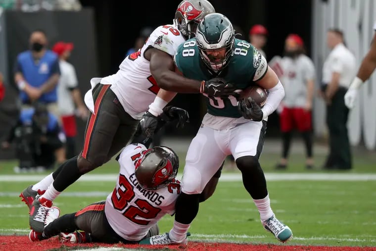 Philadelphia Eagles tight end Dallas Goedert (88) picks up the first down against Tampa Bay Buccaneers safety Mike Edwards (32) and Tampa Bay Buccaneers inside linebacker Devin White (45) in the second quarter Sunday, January 16, 2022 at at Raymond James Stadium in Tampa, Fla.