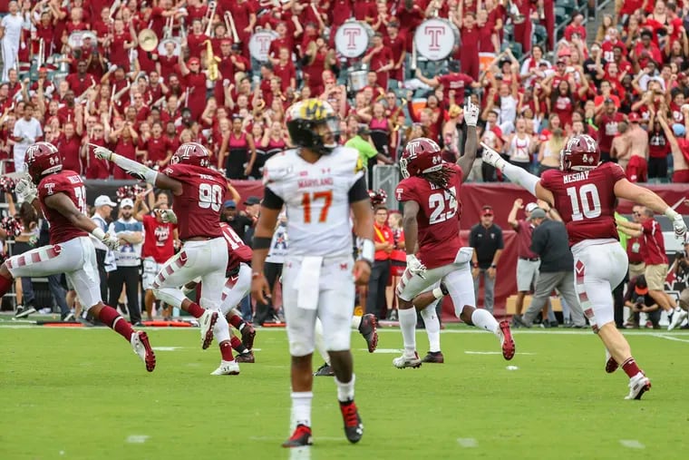 Temple defenders celebrate after successfully stopping Maryland from scoring on a fourth down that would have given them the lead in the fourth quarter while Maryland quarterback Josh Jackson (17) walks off the field at Lincoln Financial Field in Philadelphia on Saturday, Sept. 14, 2019. Temple won, 20-17.