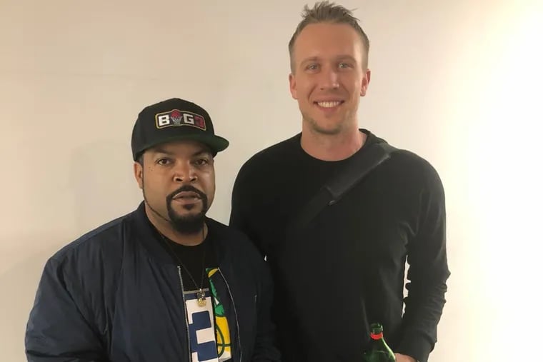 Ice Cube (left)standing next to Eagles quarterback, Nick Foles, who is wearing Swet Tailor top and pant,  the unofficial clothing of Eagles off the field. Ice Cube isn't wearing Swet Tailor, he's just cool.