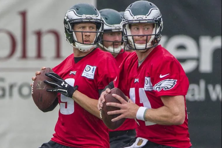 Eagle quarterbacks Carson Wentz, #11, right, and Nick Foles, #9, left, look to be in step as they go through a footwork drill in an August  practice .08/15/2017 MICHAEL BRYANT / Staff Photographer