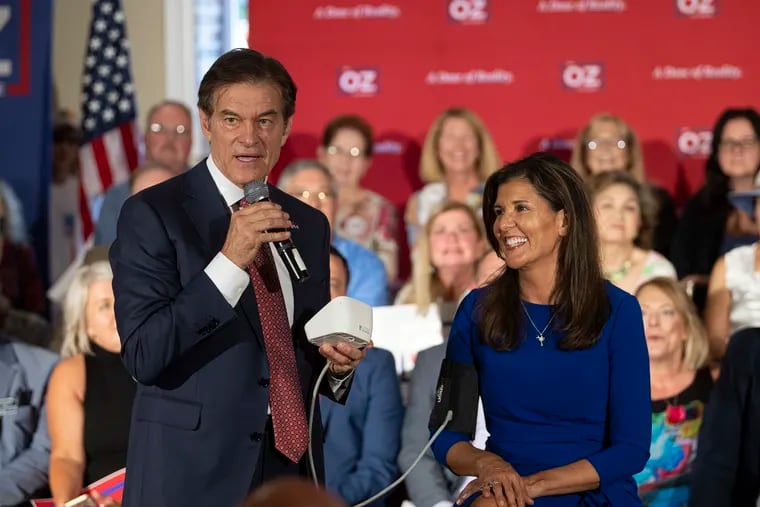 Mehmet Oz, the Republican nominee for U.S. Senate in Pennsylvania, takes the blood pressure from former South Carolina governor and ambassador to the United Nations Nikki Haley on Thursday in Springfield, Pa.