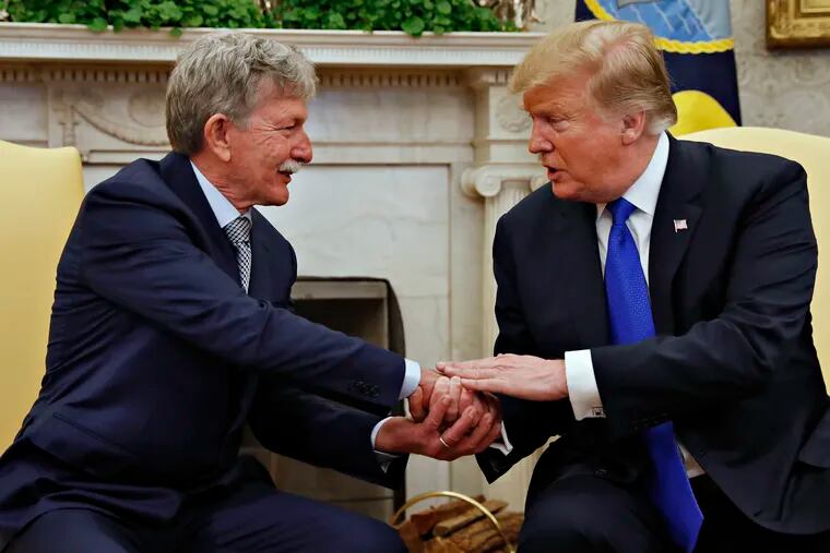 President Donald Trump, right, shakes hands with Danny Burch, a former U.S. hostage held in Yemen, Wednesday, March 6, 2019, in the Oval Office of the White House in Washington. (AP Photo/Jacquelyn Martin)