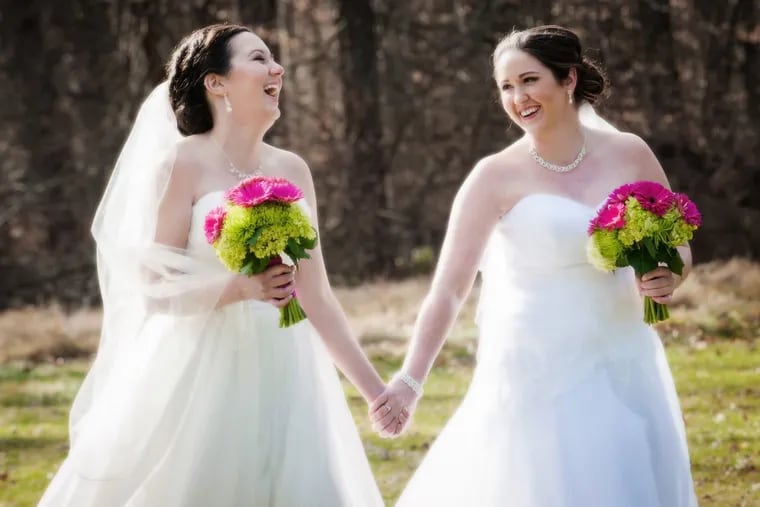 Meagan Prime, left, and Angelina Jacob, right share a laugh on their wedding day at Brantwyn Estate.