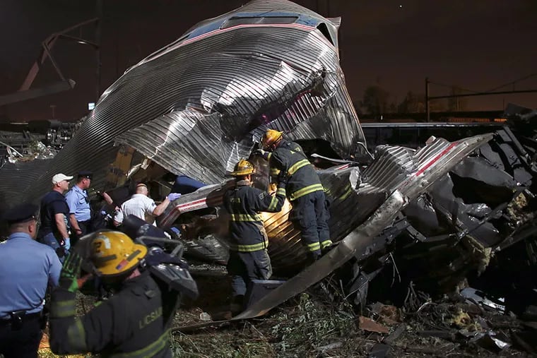 Emergency personnel work the scene of a train wreck, Tuesday, May 12, 2015, in Philadelphia. An Amtrak train headed to New York City derailed and crashed in Philadelphia. JOSEPH KACZMAREK / Associated Press