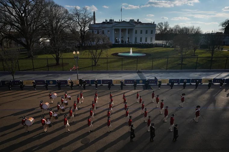 Participants pass by the White House during the "presidential escort" to the White House following the inauguration in Washington, D.C., on Wednesday, Jan. 20, 2021.