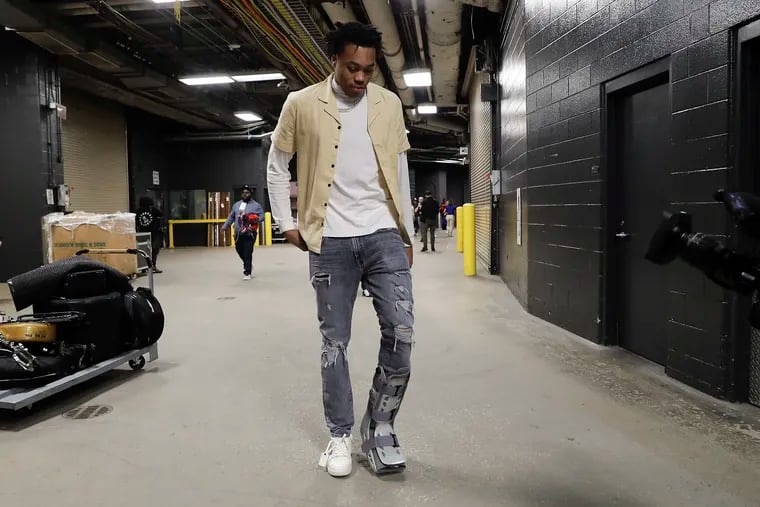 Toronto Raptors forward Scottie Barnes walks into the Wells Fargo Center with a walking cast on his leg before the Raptors play the Sixers in Game 2.