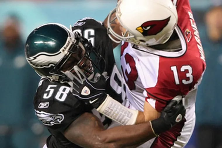 Defensive end Trent Cole forces Cardinals&#0039; Kurt Warner into an incomplete pass.