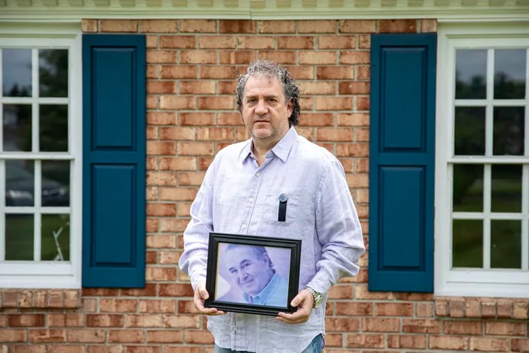 Ian Horowitz, 53, of Chester Springs, holds a photo of his dad, Edward Horowitz, who died at 81 from the coronavirus at Southeastern Veterans' Center. "I was scared to death that it would get into his building and that’s exactly what happened.”