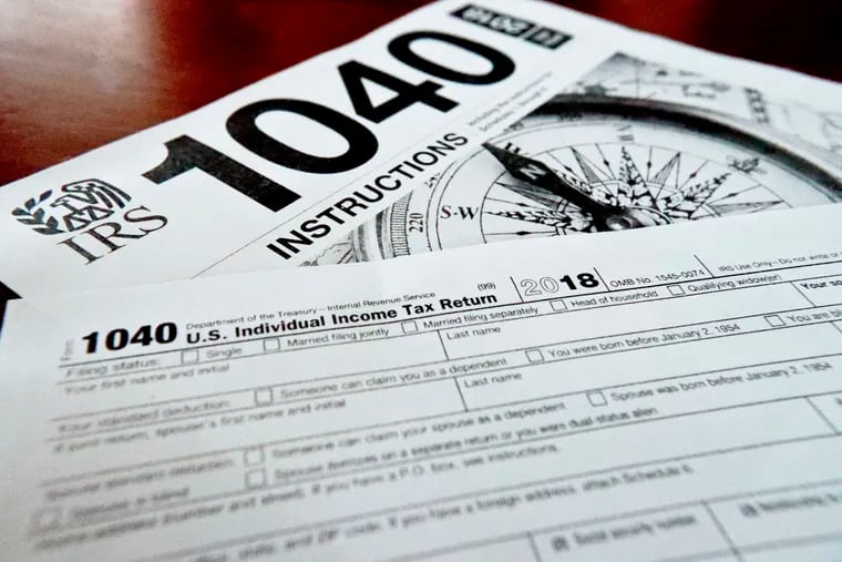 FILE- This Feb. 13, 2019, file photo shows multiple forms printed from the Internal Revenue Service web page that are used for 2018 U.S. federal tax returns in Zelienople, Pa. If you don’t think you will be able to complete and file your taxes on time, request an extension. Filing an extension helps taxpayers avoid penalties for a late return, according to the IRS.  (AP Photo/Keith Srakocic, File)