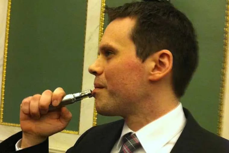 Gregory Conley of Medford, NJ, told a Philadelphia Council committee hearing testimony on bills to restrict e-cigarettes Thursday that a ban on their use in restaurants and other public places would be impossible to enforce. He used this e-cigarette 20 or 25 times while sitting in the back of the room during the hearing, he told them, and no one noticed. (Photo was taken after the hearing.) Photo: Don Sapatkin / staff