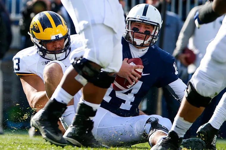 Penn State quarterback Christian Hackenberg is sacked by Michigan defensive end Chris Wormley.