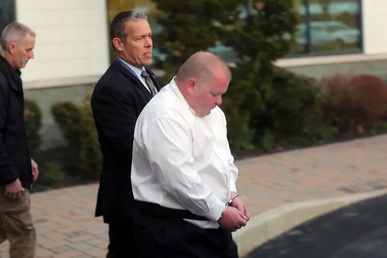William Hickman, right, who worked as a pharmaceutical representative and ran the company Boardwalk Medical LLC, is escorted from the FBI office in Linwood, N.J., Friday, March 15, 2019. Authorities say a police officer and three firefighters are among seven people recently charged in a $50 million prescription drug scheme that has already produced nearly two dozen guilty pleas.