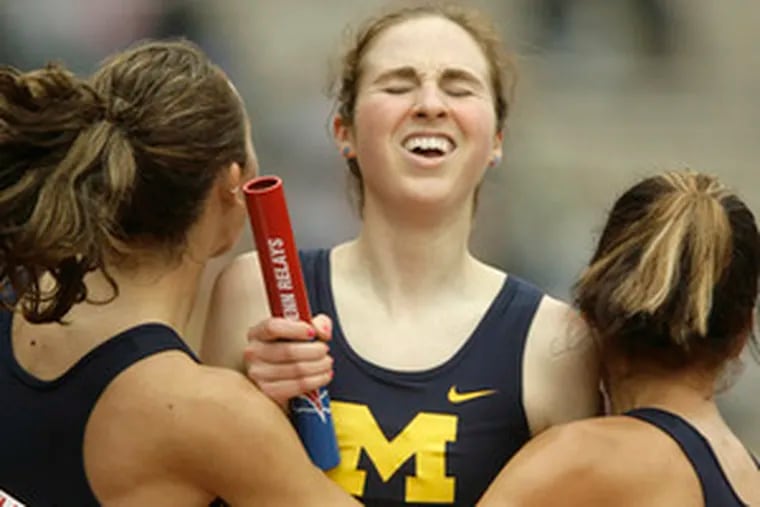 Michigan&#0039;s Nicole Edwards (center) celebrates with Geena Gall (left) and Anna Willard after their team won the 4x1,500-meter race.