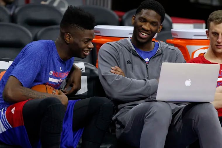 Joel Embiid (right) shares a laugh with Nerlens Noel before a 76ers game in the 2014-15 season.
