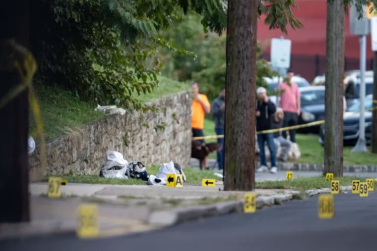 Dropped football equipment and evidence markers at the scene of a shooting outside Roxborough High School last year. Nicolas Elizalde, 14, was killed and four others were injured.