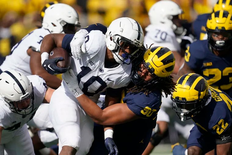 Michigan linebacker Mike Morris tackles Penn State running back Nicholas Singleton in the first half of the Lions' 41-17 loss.