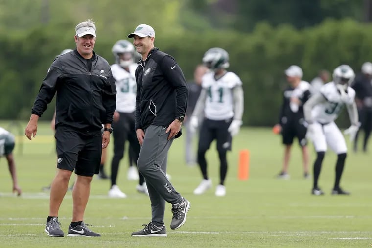 Eagles' head coach Doug Pederson, left, and offensive coordinator Mike Groh, right, talks as the Eagles hold OTA's at the NovaCare Complex in Philadelphia, PA on May 29, 2018. DAVID MAIALETTI / Staff Photographer