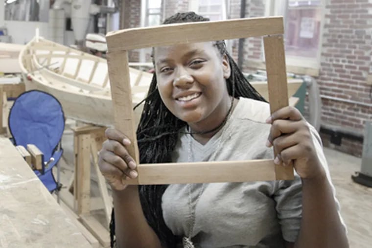 Alisha Rothwell, 14, made this picture frame during down time at the Wooden Boat Factory. (Elizabeth Robertson / Staff Photographer)