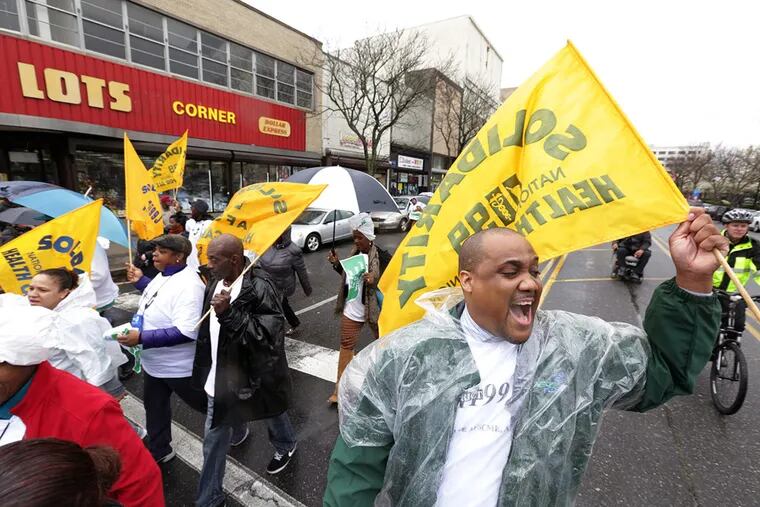 Union worker Marcell Moore, of Newark, chants pro-union slogans during a march to City Hall in Atlantic City on Tuesday April 12, 2016, in support of the city in light of a state takeover.