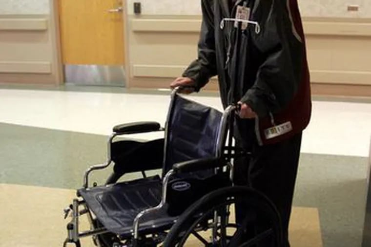 Jim Sullivan takes a wheelchair to a patient at the Tucson, Ariz., Veterans Affairs Medical Center. Despite battling cancer, Sullivan still volunteers six days a week at the Medical Center.