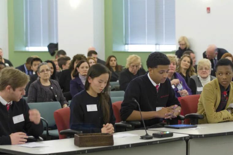 Students of the String Theory Charter schools spoke at a charter school application hearing to encourage the approval of their schools' application.