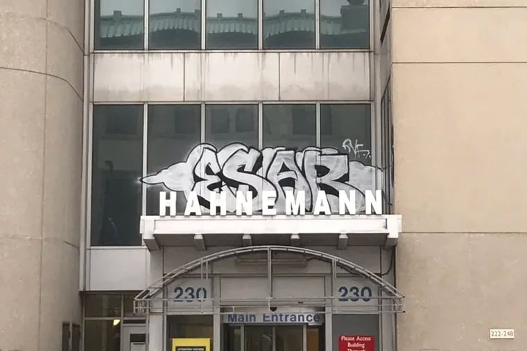 Graffiti scrawled across the entrance to the now-shuttered Hahnemann University Hospital in Center City Philadelphia.